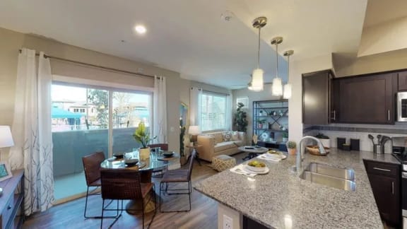 a kitchen and living room with a counter and a sink