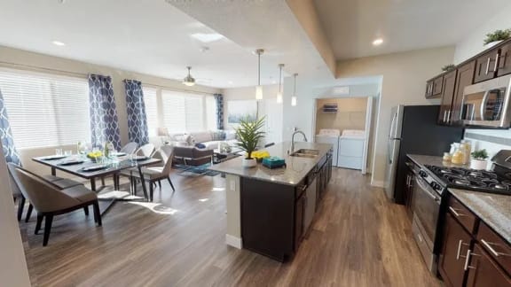 a kitchen and living room with a table and chairs