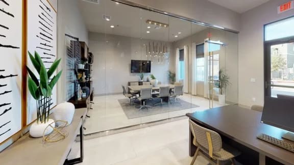a conference room with a table and chairs and a tv