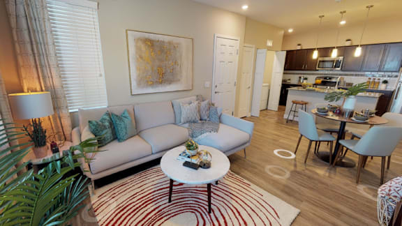 A living room with a grey couch and a coffee table.