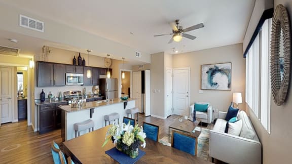 a living room and kitchen with a dining room table