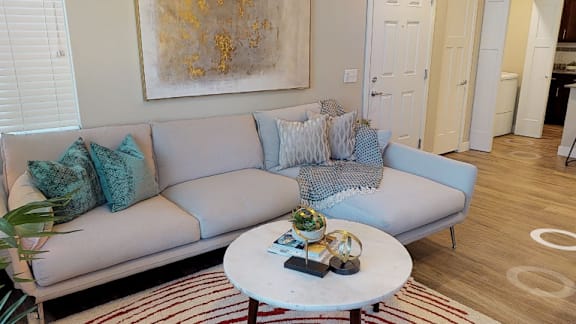 A living room with a grey couch and a coffee table.