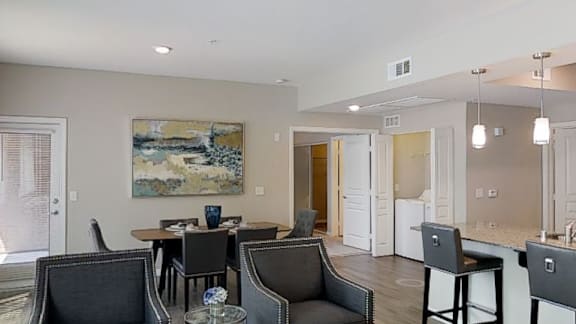 A dining room with a table set for four.