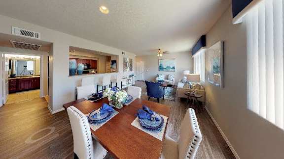 a kitchen and dining room with a table and chairs
