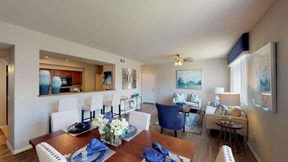 a kitchen and living room with a table and chairs