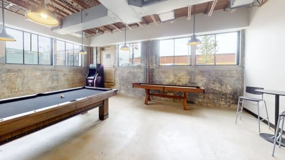 an empty room with a pool table and a ping pong table