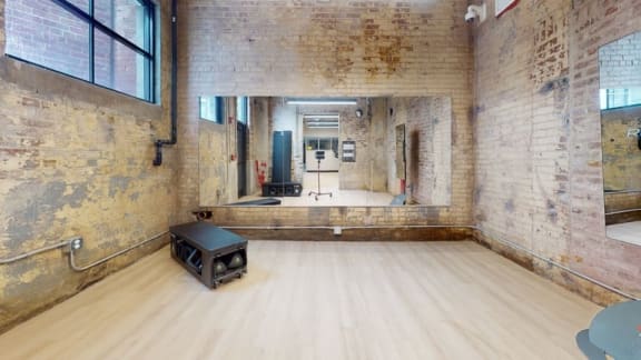 a large mirror in a large room with a wood floor