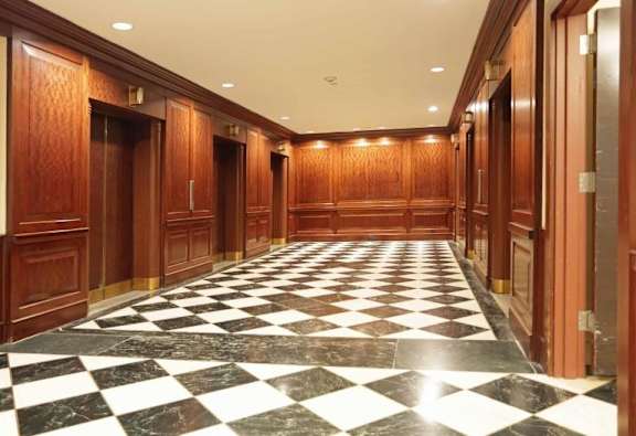 A long hallway with a black and white checkered floor.