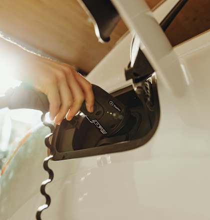 A person is charging an electric car.