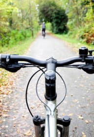 a person riding a bike down a trail