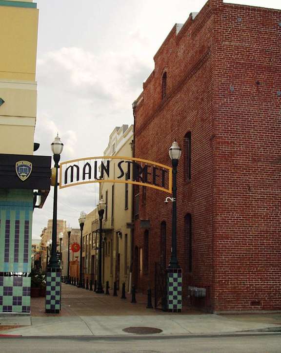 a street with a brick building and a sign for main street