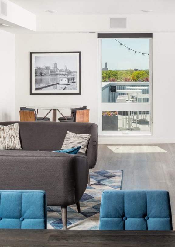a living room with a couch and a chair in front of a window