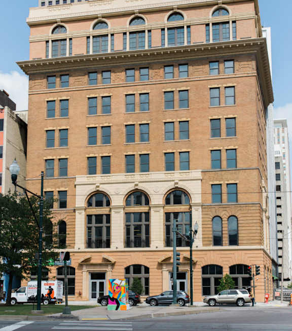 A postcard from the Pythian Temple in New Orleans, Louisiana, featuring various photographs of the building and events held there.