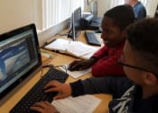Thumbnail 2 of 13 - Mutual Housing residents use a lab computer