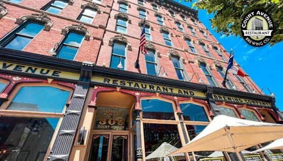 The image shows a red brick building with a sign that reads "Avenue Restaurant and Brewing Co."