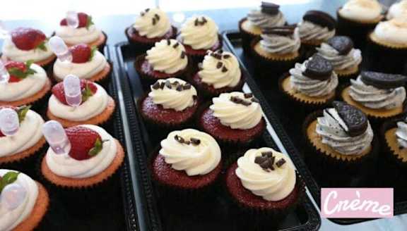 A tray of cupcakes with different toppings.