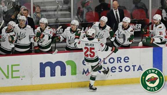 Hockey players in white jerseys with the number 25 on the back of the jersey.