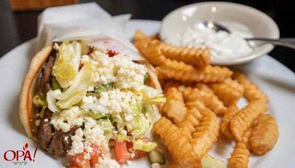 A plate of food with a sandwich, fries and a side of dip.
