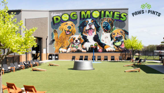 A mural of dogs is painted on the side of a building.