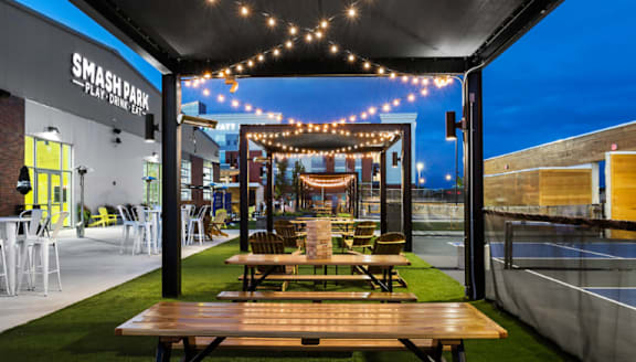 A Smash Park Playground is set up under a canopy with lights strung up.