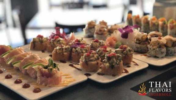 A variety of Thai food is displayed on white plates.