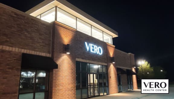 The Vero Health Center building is lit up at night.