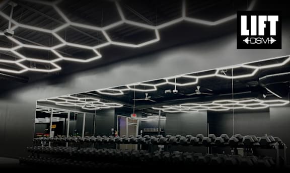 A gym with a black and white color scheme and a spider web ceiling design.