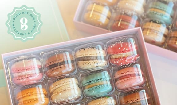 A box of macarons with a variety of colors.