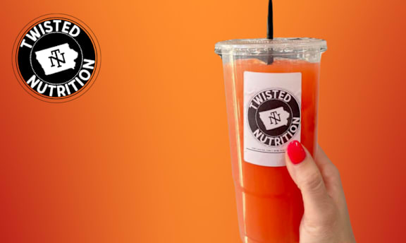 A hand is holding a Twisted Nutrition drink.