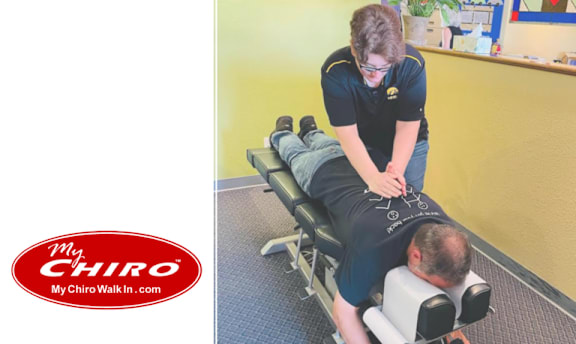 A man is receiving a back massage from a therapist in a room with a yellow wall.
