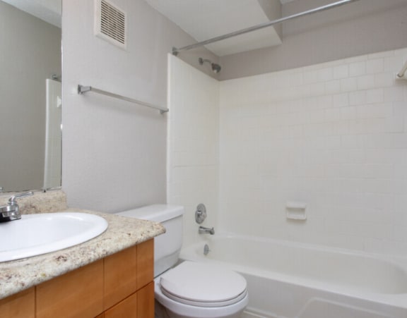 a bathroom with a sink toilet and a tub