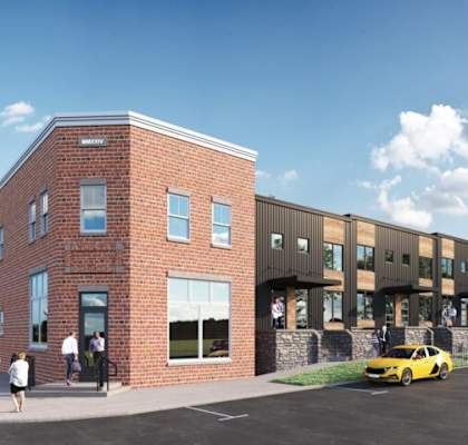 A modern building with a parking lot in front.