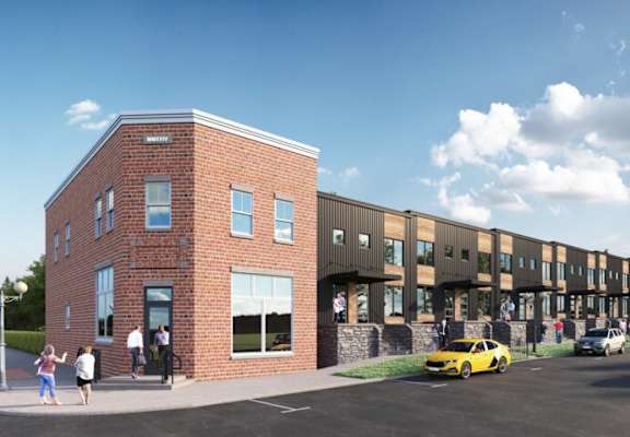 A modern building with a parking lot in front.