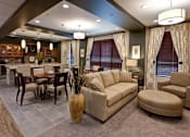 Thumbnail 6 of 12 - A living room with a grey carpet and a beige sofa.
