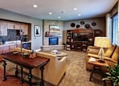 Thumbnail 8 of 12 - A living room with a fireplace and a television.