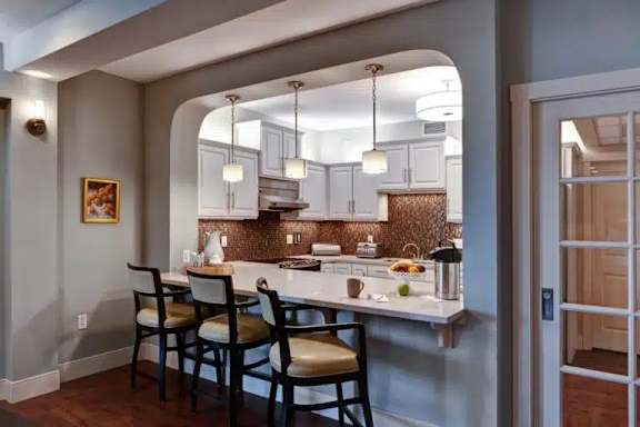 A kitchen with a table and chairs.