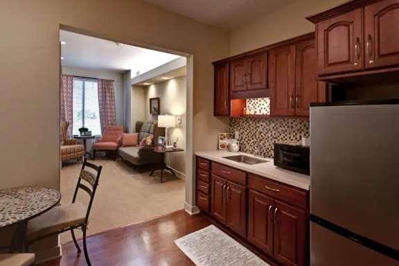 A kitchen with wooden cabinets and a refrigerator.