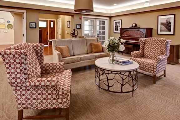 A living room with patterned chairs and a sofa.
