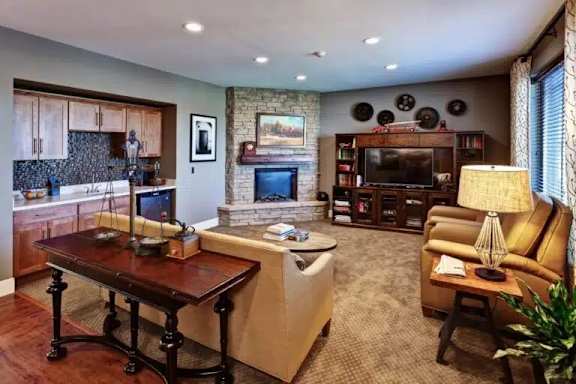 A living room with a fireplace and a television.