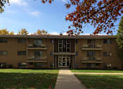 Thumbnail 25 of 33 - a large apartment building with a sidewalk in front of it