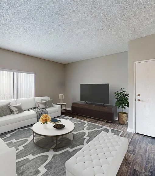 A well-lit, modern kitchen and living room with a dining area.