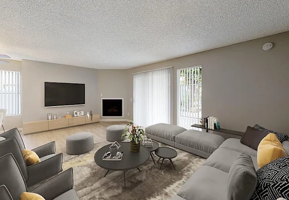 A modern living room with grey couches and a coffee table.