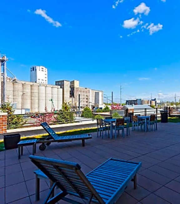 A patio with tables and chairs.
