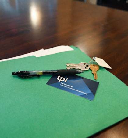 a pair of keys sitting on top of a green piece of paper