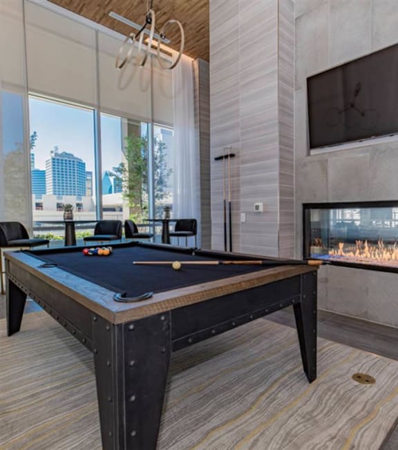 resident lounge with billiards, fireplace and a TV at The Gabriella apartments
