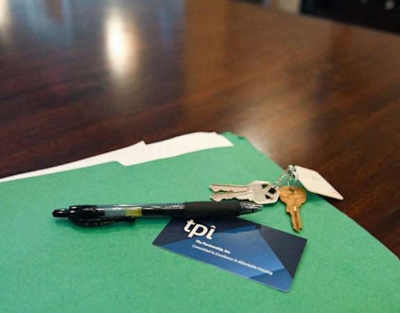 a pair of keys sitting on top of a green piece of paper