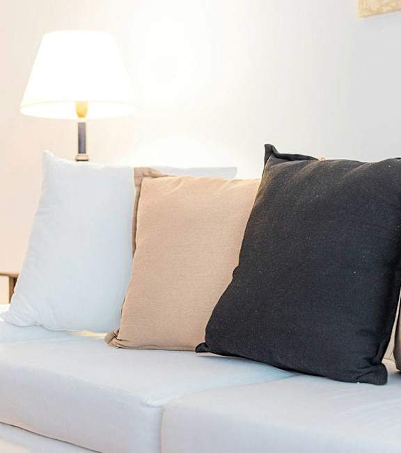 a living room with a couch and a lamp