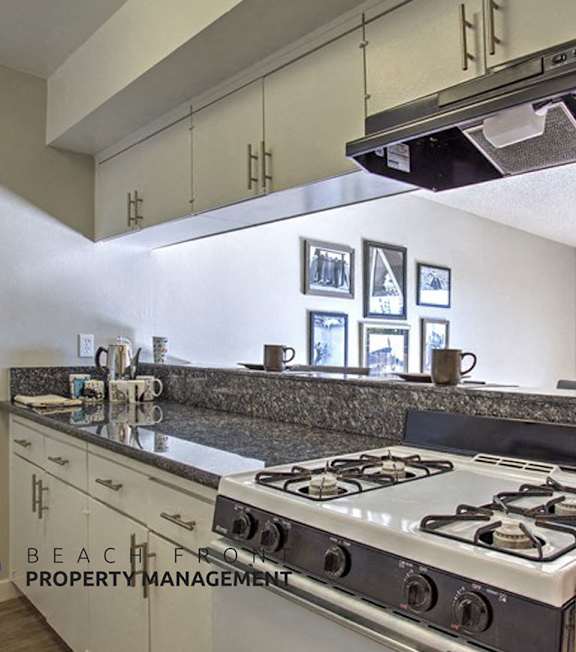 A well-lit, modern kitchen and living room with a dining area.