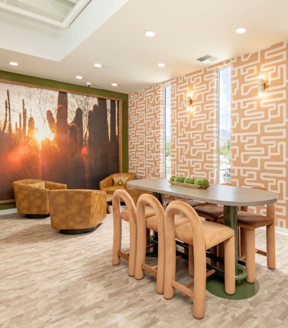 A room with a table and chairs and a wall with a maze design.