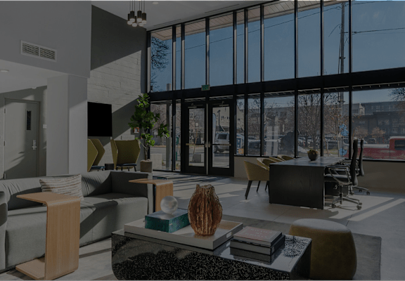 A modern living room with a large window and a view of the city.